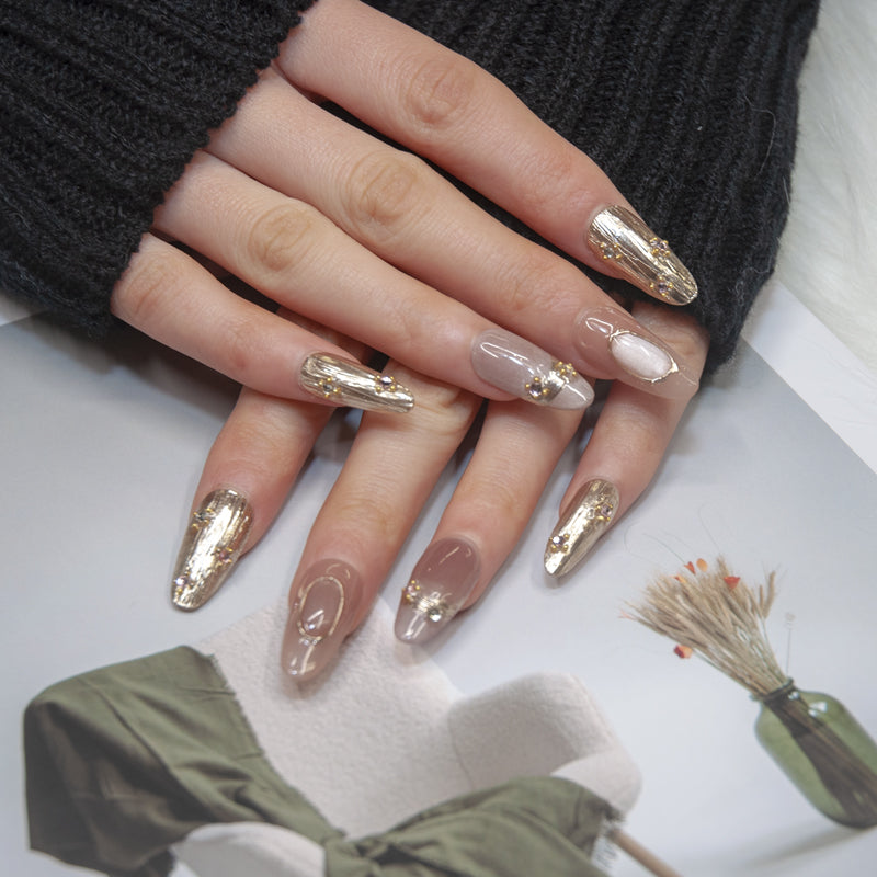 Elegant nude nails with 3D metallic frames and rhinestone accents