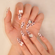 Handmade pink nails with brown leopard spots, cartoon cat art, and bow design