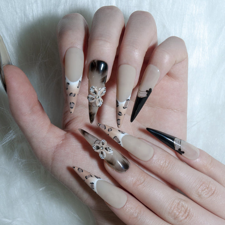 Handmade animal print nails with 3D floral accents and glossy black French tips