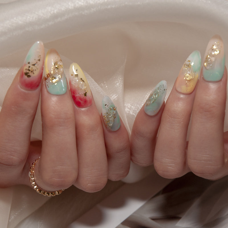 Spring gradient press-on nails featuring pink, mint, and yellow with gold foil