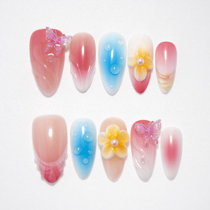 Pink blue gradient press-on nails with 3D yellow flowers and pink butterfly charms