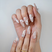 Luxury press-on nails in champagne nude with pearls for bridal and party looks