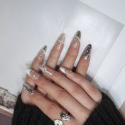 Handmade French press-on nails with metallic silver and white accent designs
