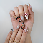 Statement press-on nails with 3D flower embellishments, heart prints and glitter stripes