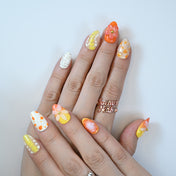 Bright citrus press-on nails with 3D flowers, yellow ombré and orange polka dots