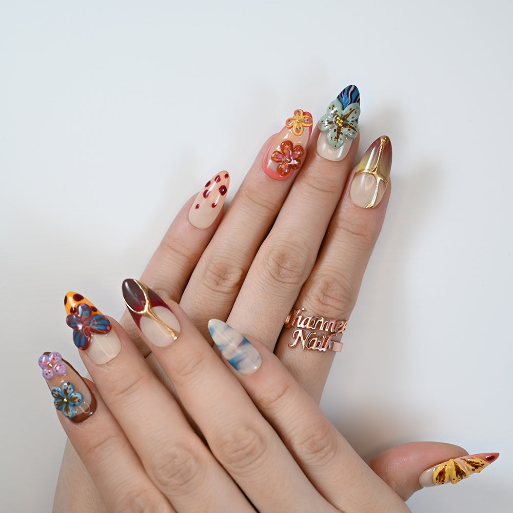 Multicolor summer-inspired press-on nails with 3D floral art and bold patterns