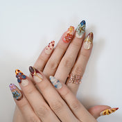Multicolor summer-inspired press-on nails with 3D floral art and bold patterns