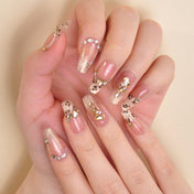 Luxury animal print nails with gold glitter tips and crystal embellishments