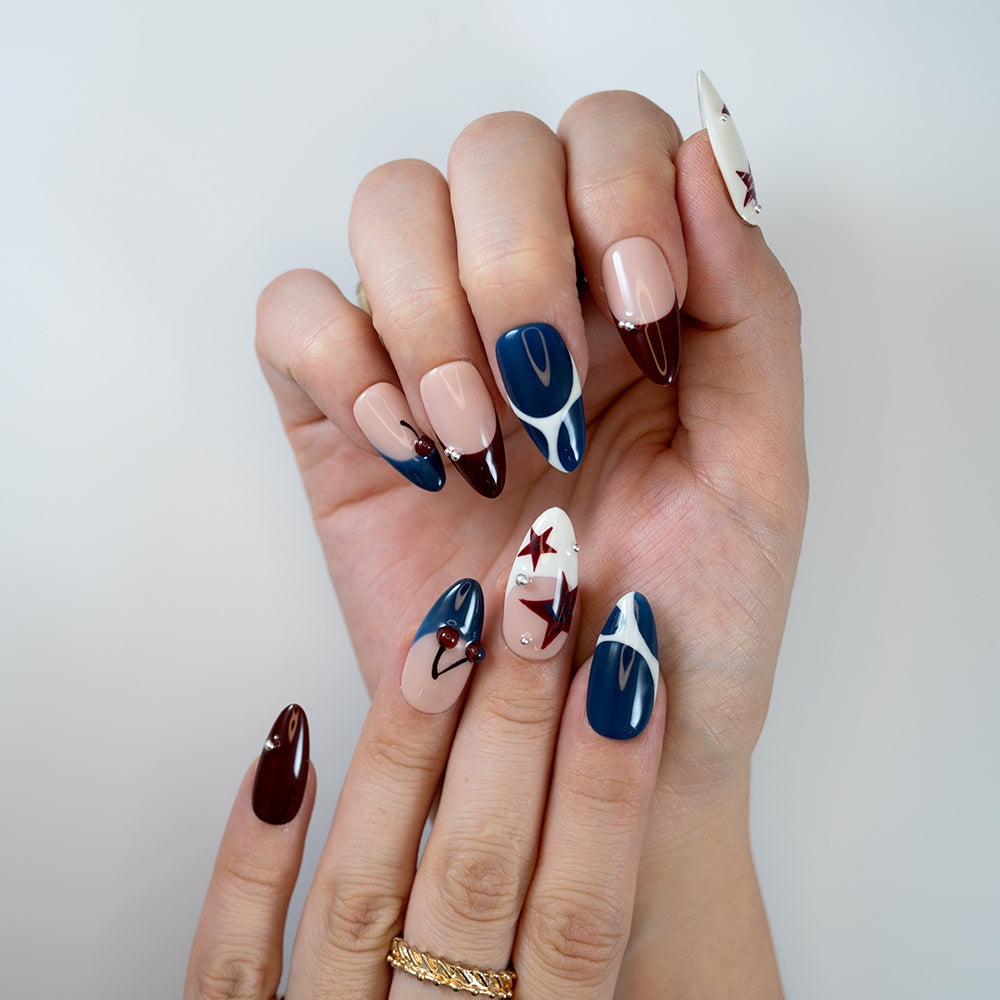 Navy, burgundy and nude nail set with pearl accents and bold color blocking