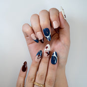 Navy, burgundy and nude nail set with pearl accents and bold color blocking