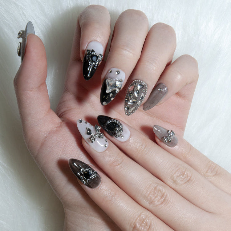 Luxury gradient press-on nails featuring large crystal gems and heart charms