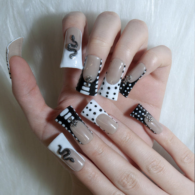 Monochrome fashion nails with zebra stripes, 3D snake, bow, and star studs