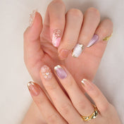 Luxury ocean theme nails with pearl centerpiece, shimmer pink, and shell tips