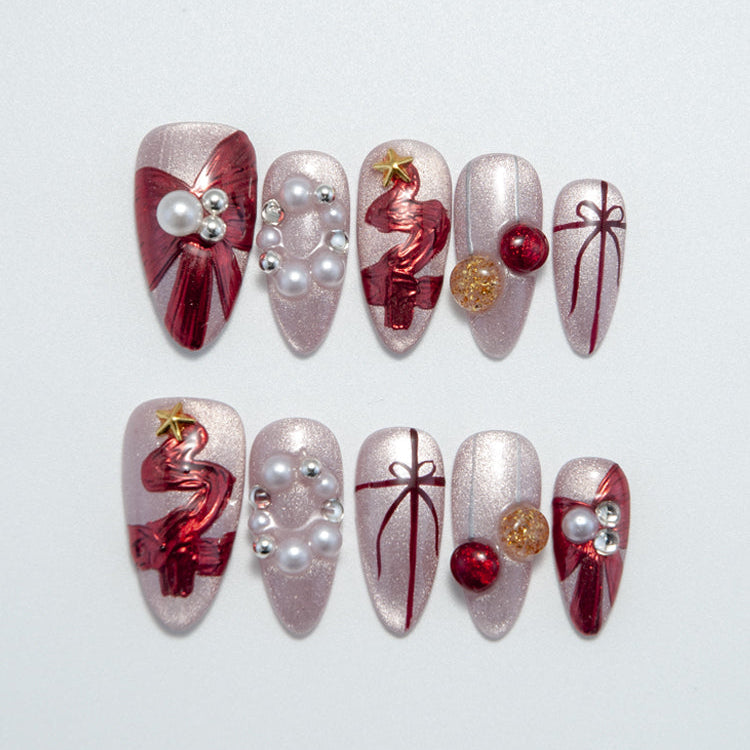 Medium almond press-on nails with red gift bow design, 3D pearls, and glitter base