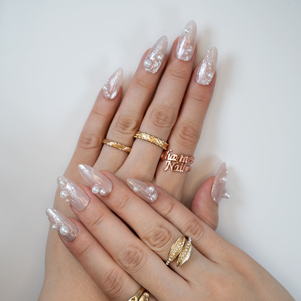 Textured nude press-on nails with pearl charms, perfect for wedding nails