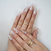 Textured nude press-on nails with pearl charms, perfect for wedding nails