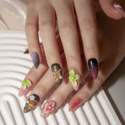 Pink, brown, and purple ombre nails with tropical flower designs