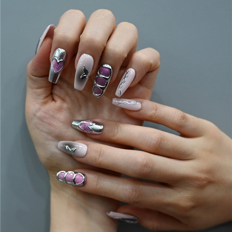 Edgy glam nails with 3D silver metal art, heart shapes, and sparkling purple-pink glitter