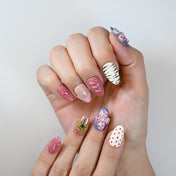 Fun and unique press-on nails with glossy pink, bold prints and fruity motifs