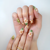  Green and beige floral nails featuring western cowhide pattern and almond shape