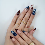Stylish handmade press-on nails with Y2K inspired star motif and deep color palette