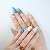 Mermaid-inspired press-on nails with iridescent seashell and cosmic design