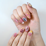 Pink nails with gradient tips and decorative dots