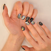 Starry night pedicure press-ons featuring ocean-inspired gold decorations