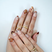 Elegant handmade press-ons with amber tone flowers, leopard print French tips and gold details