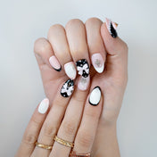 Luxury 3D heart and bow press-on nails in black, white, and pink with pearl embellishments