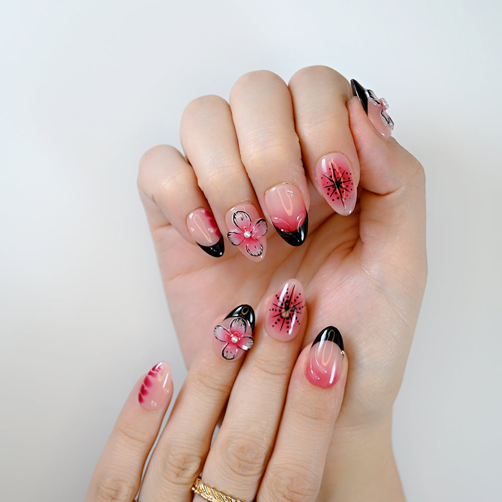  Sweet yet edgy floral nail set with black French tips and vivid pink blossoms
