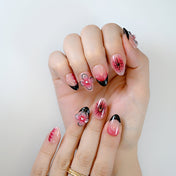  Sweet yet edgy floral nail set with black French tips and vivid pink blossoms