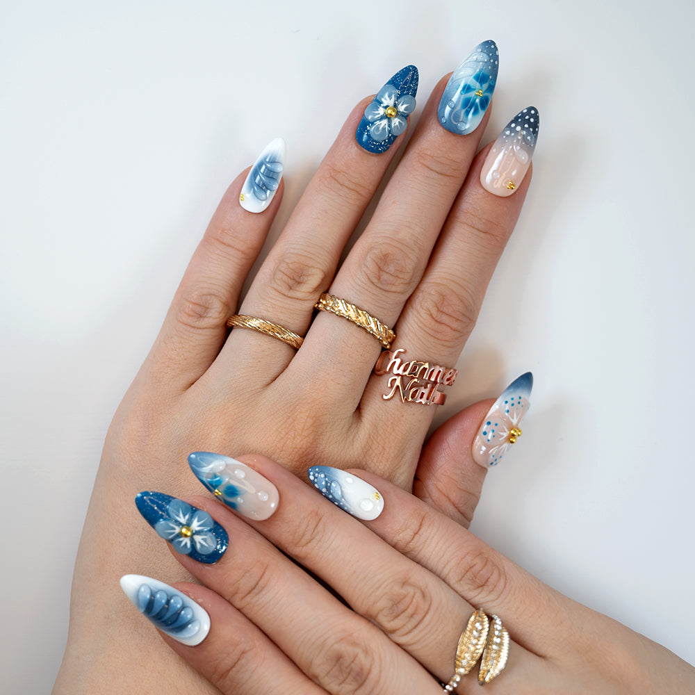  Beach-inspired summer nails featuring blue gradients, 3D petals, and glossy pearl finish