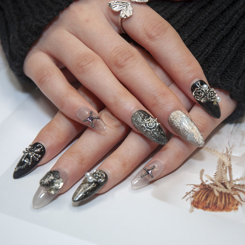 Luxury handmade nails with spider web design, pearls, and gemstone charms