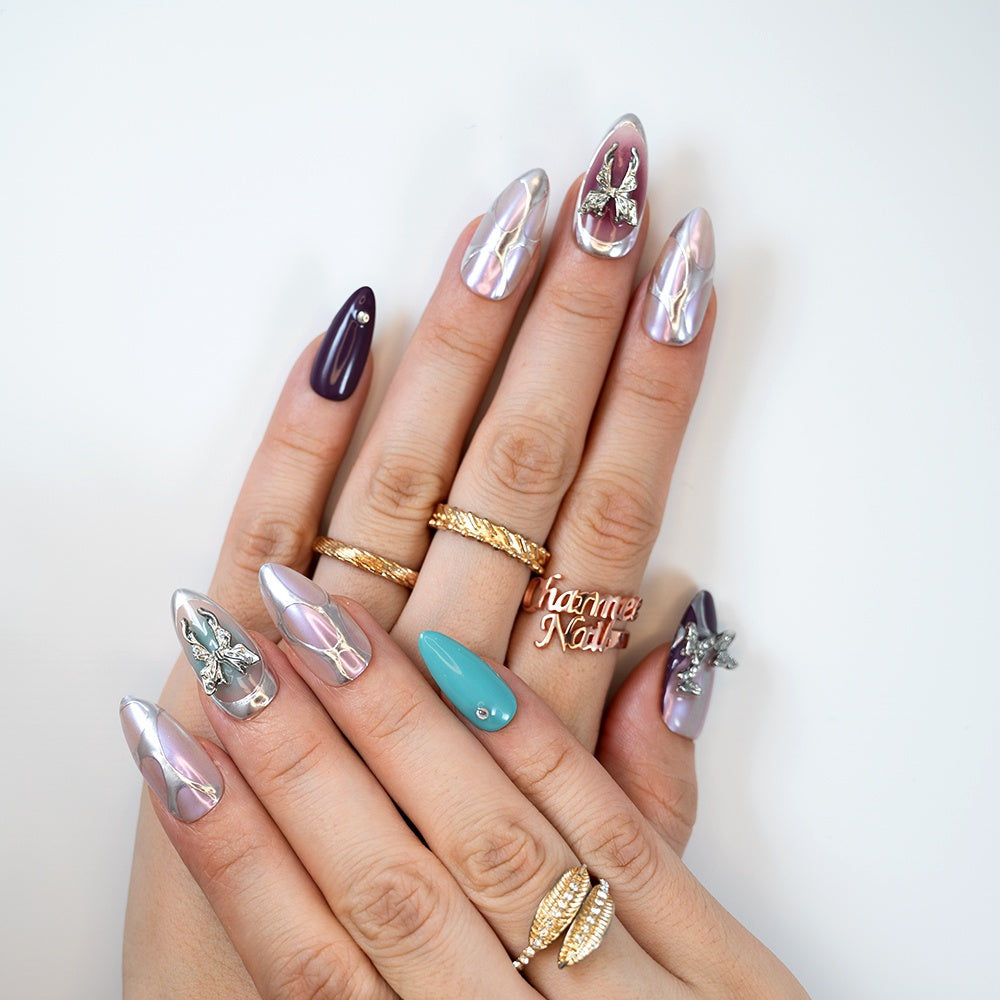 Medium almond press-on nails in pastel chrome with 3D butterfly decorations