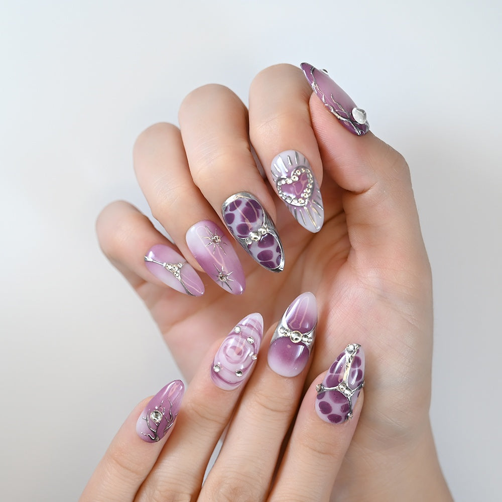 Handmade purple ombre press-on nails with marble effect and metallic embellishments