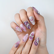 Handmade purple ombre press-on nails with marble effect and metallic embellishments