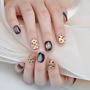Luxury animal print nails with shimmering gold base and brown leopard spots