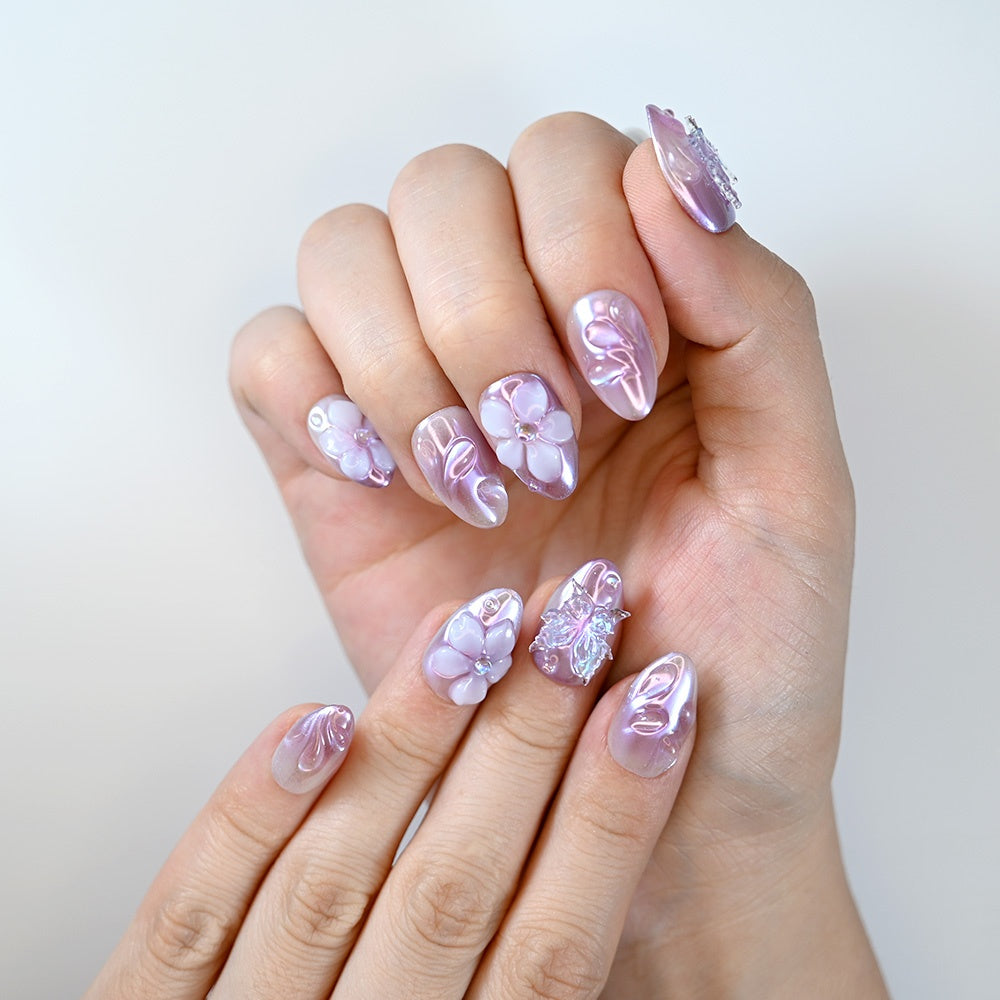 Iridescent lilac press-on nails with 3D flower embellishments and glossy finish”