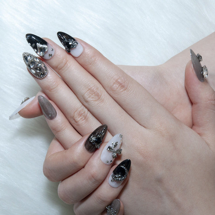 Handmade press-on nails with glitter finish, moon charm, and bow embellishments