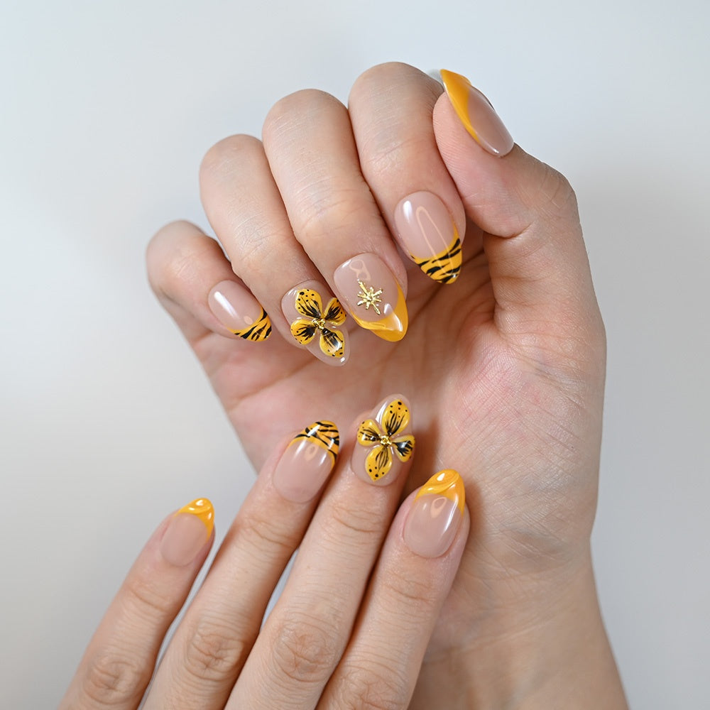 Handmade nude and yellow nails with tiger print tips and 3D floral design