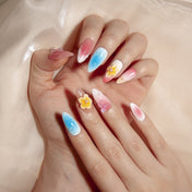 Ombre summer press-on nails featuring tropical plumeria flowers and butterfly accents