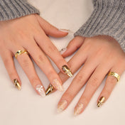 Handmade almond nails in white and gold with festive snowflake art and 3D embellishments