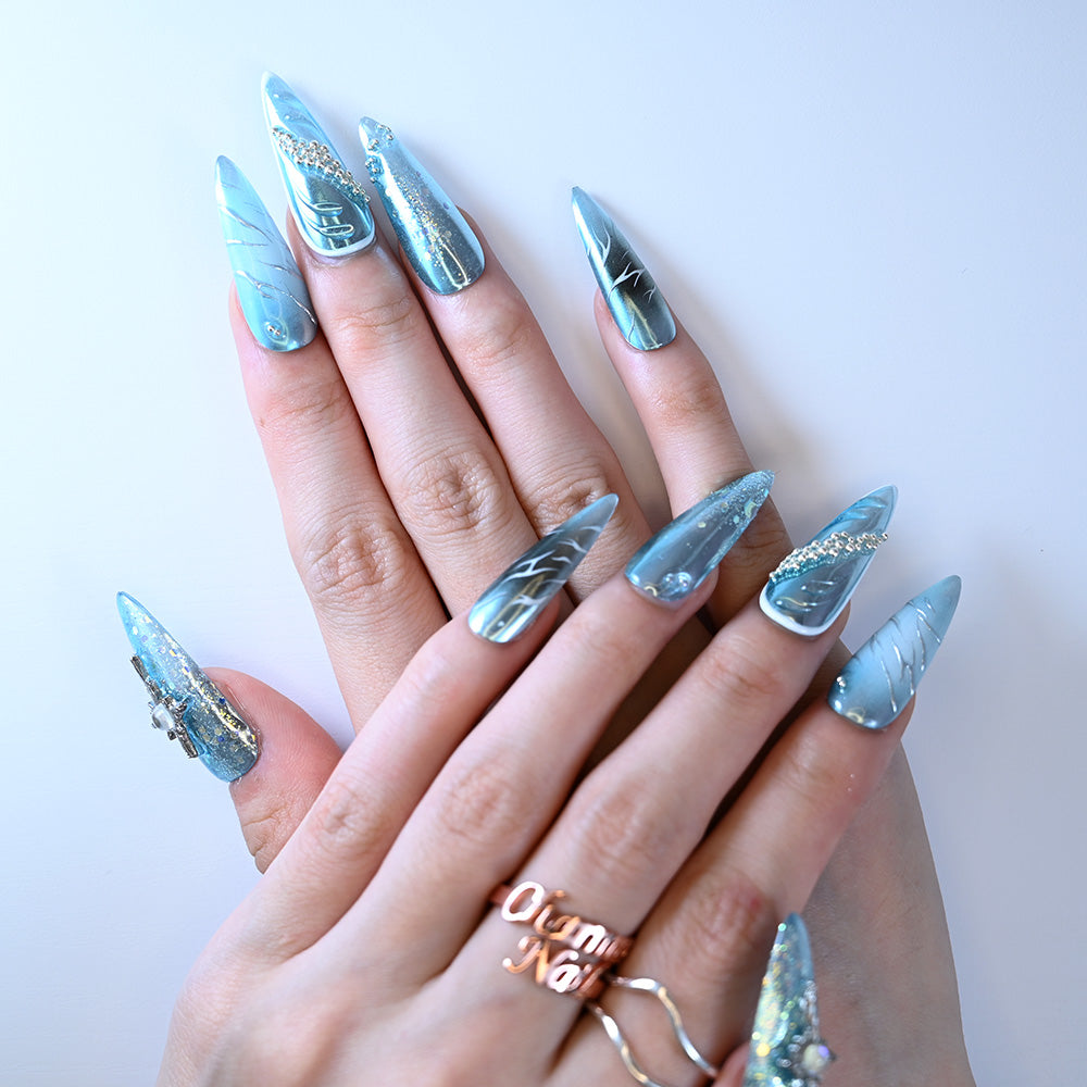 Long stiletto blue metallic press-on nails with rhinestones and gold foil