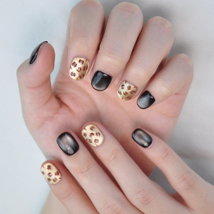 Chic gold and black leopard print press-on nails for bold fashion looks