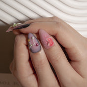 Luxury floral press-on nails with pearl chains and ocean-inspired details