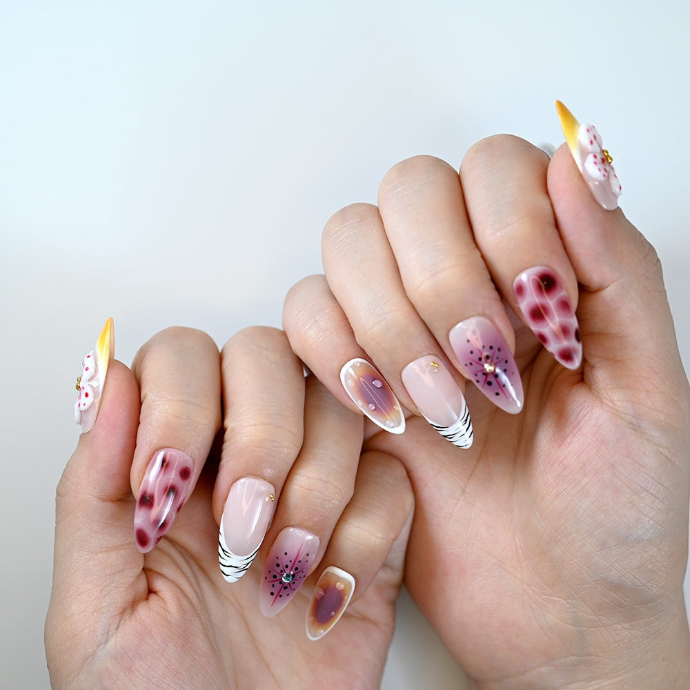  Nude almond press-on nails with burgundy leopard spots, zebra French tips and 3D white flower