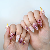  Nude almond press-on nails with burgundy leopard spots, zebra French tips and 3D white flower