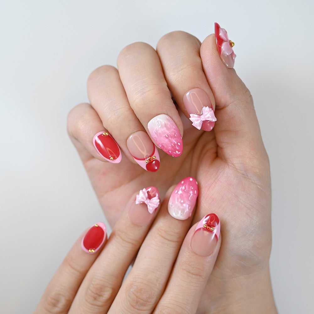 Romantic pink red nails with berry gradient, gold bead accents, and cute bows