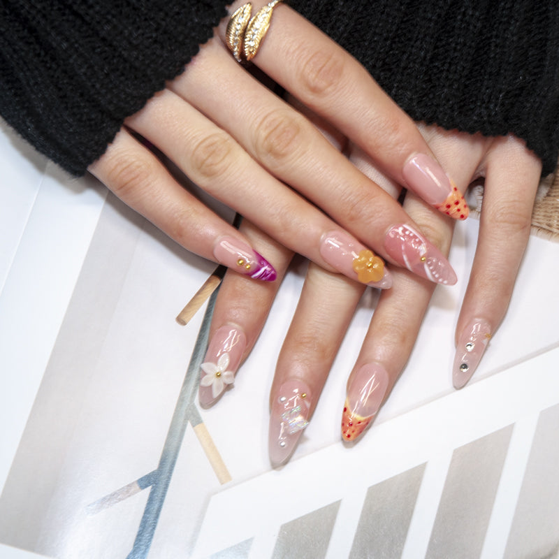 Glossy nude nails with purple French tips, polka dot patterns, and 3D decorations